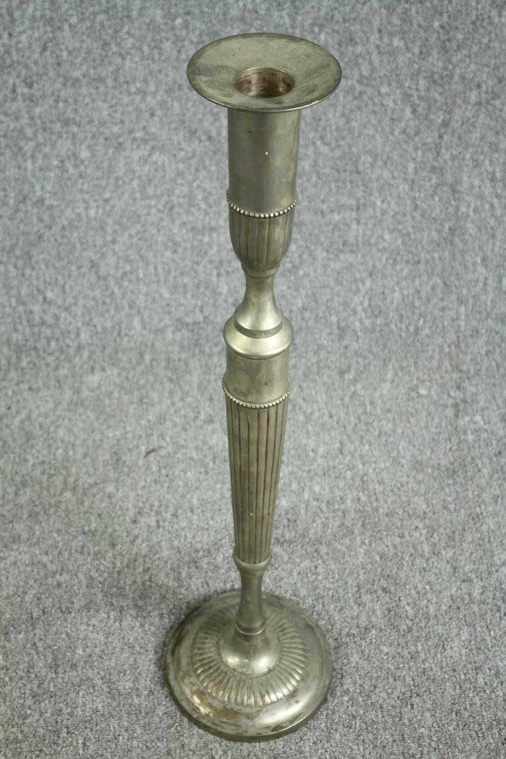 A pair of elongated silver plated brass candlesticks. In the neoclassical style. Circa 1930. H.80cm. - Image 3 of 4