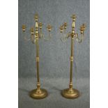 A pair of ornate candle holders, each with four arms for holding candles and a central