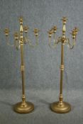 A pair of ornate candle holders, each with four arms for holding candles and a central