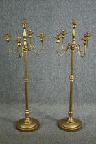 A pair of ornate candle holders, each with four arms for holding candles and a central