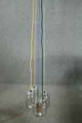 A ceiling light made up of a cluster of jam jars with coloured cable. L.147cm. Proceeds from this