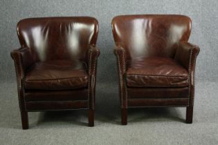 A pair of contemporary vintage style tub armchairs in tan leather and studded upholstery. H.73cm. (