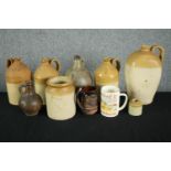 A collection of four 19th century stoneware honey glaze flagons with impressed maker's marks along