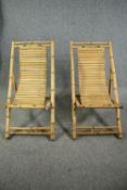 A pair of slatted bamboo deck chairs.