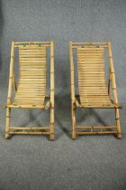 A pair of slatted bamboo deck chairs.