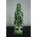 A 20th century carved spinach jade figure of a Chinese elder. H.43cm.