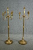 A pair of ornate candle holders, each with four arms for holding candles and a central