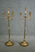 A pair of ornate candle holders, each with four arms for holding candles and a central