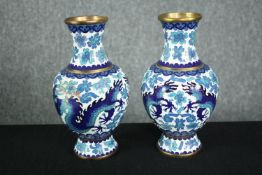 A pair of Japanese blue and white cloisonné enamel vases with dragon and floral motifs. H.21cm. (