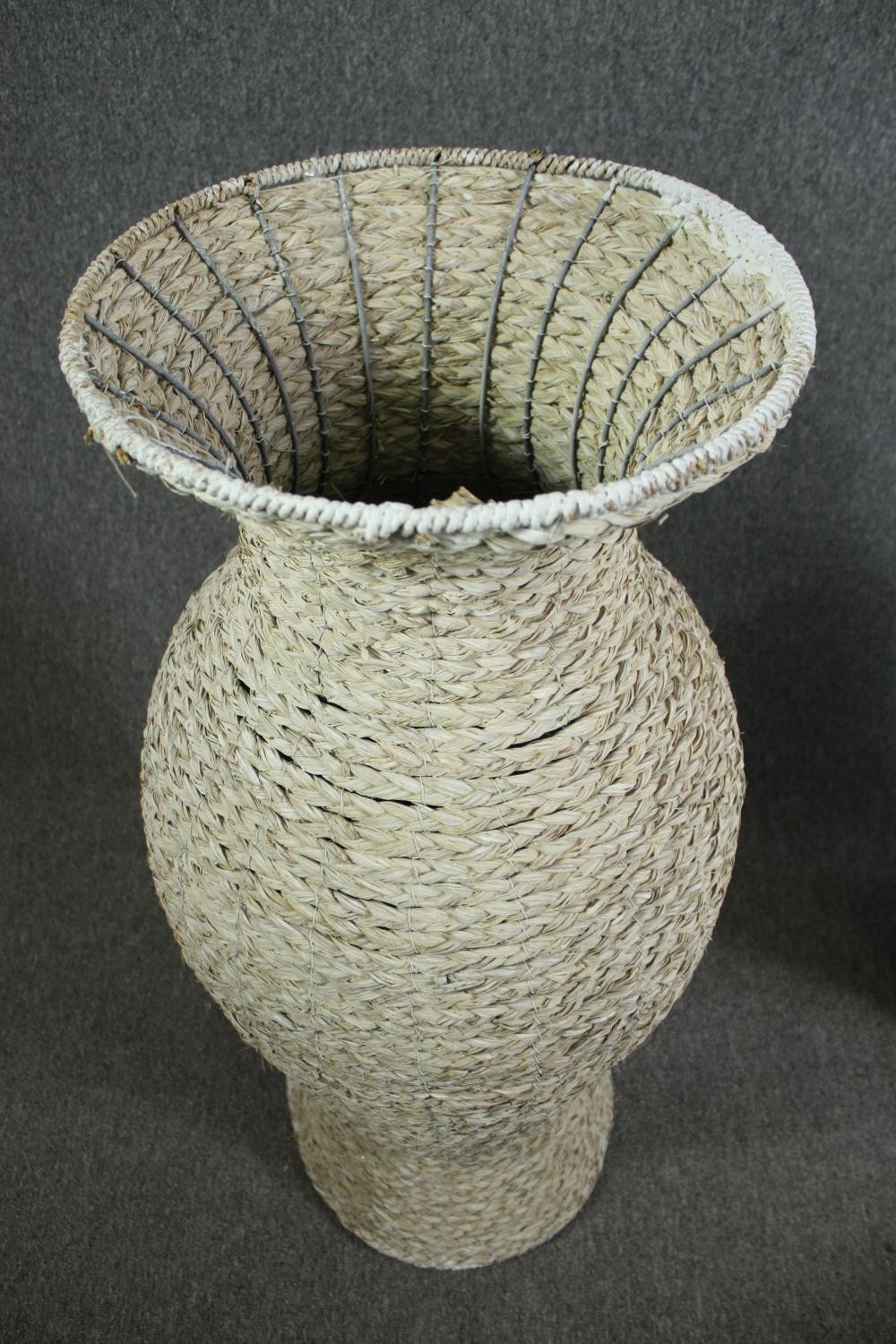 A pair of large modern rattan floor standing pots made from a metal frame with a weaved outer shell. - Image 4 of 6