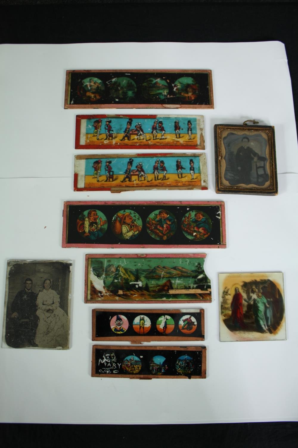 An assortment of Victorian Magic Lantern slides and portrait photographs. The slides include comical