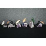 A collection of six pieces of amethyst mounted with detachable perched parrots carved from various