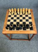 Chess table, mid century teak with tiled top along with an Isle of Lewis style chess set. H.57 W.