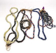 A collection of eight African venetian trade bead necklaces and four bracelets. Some with a candy