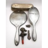 A Victorian silver dressing table set along with a silver handle and coral and silver child's