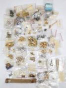 A collection of folk costume fittings, including clasps, spacers, beads and other craft items.
