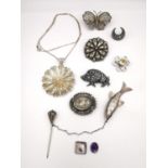 A collection of early 20th century silver brooches and silver jewellery, including a silver repousse