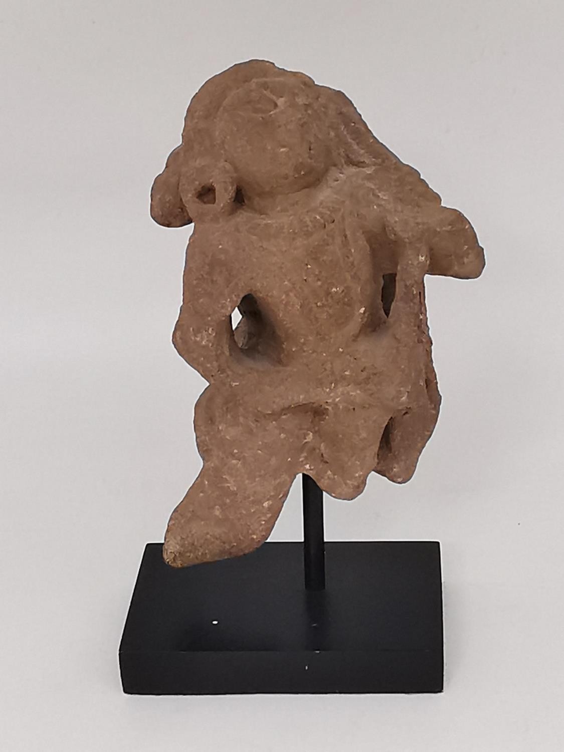 A Kushan carved red sandstone figure of a lady dancing. Possibly from an altarpiece or doorway,