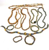 A collection of eight African venetian glass trade bead necklaces and four bracelets. The long
