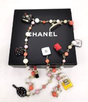 A boxed 2004 Chanel Cosmetics Sautoir necklace. Vintage Perfume and Cosmetics Charms long necklace