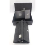 A boxed Dunhill key case and key holder black PVC and leather with impressed monogram design. (holds