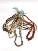 A collection of ten African trade bead necklaces, one comprised of shell discs, venetian glass