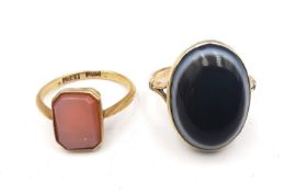 Two Victorian agate and yellow metal (tested as gold) and gold rings. One 18ct yellow gold inset
