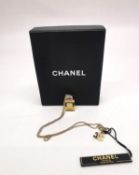 A boxed 2004 Autumn collection Chanel gold plated No5 perfume bottle & CC logo pendant necklace.