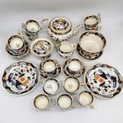 An early 19th century hand painted Imari style twelve person part tea set. Each decorated with a