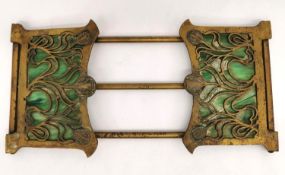 An Art Nouveau Tiffany style gilt bronze and green marbled glass book slide. The pierced brass