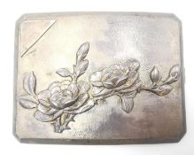 A Chinese early 20th century repousse silver cigarette case with relief flowering quince branch
