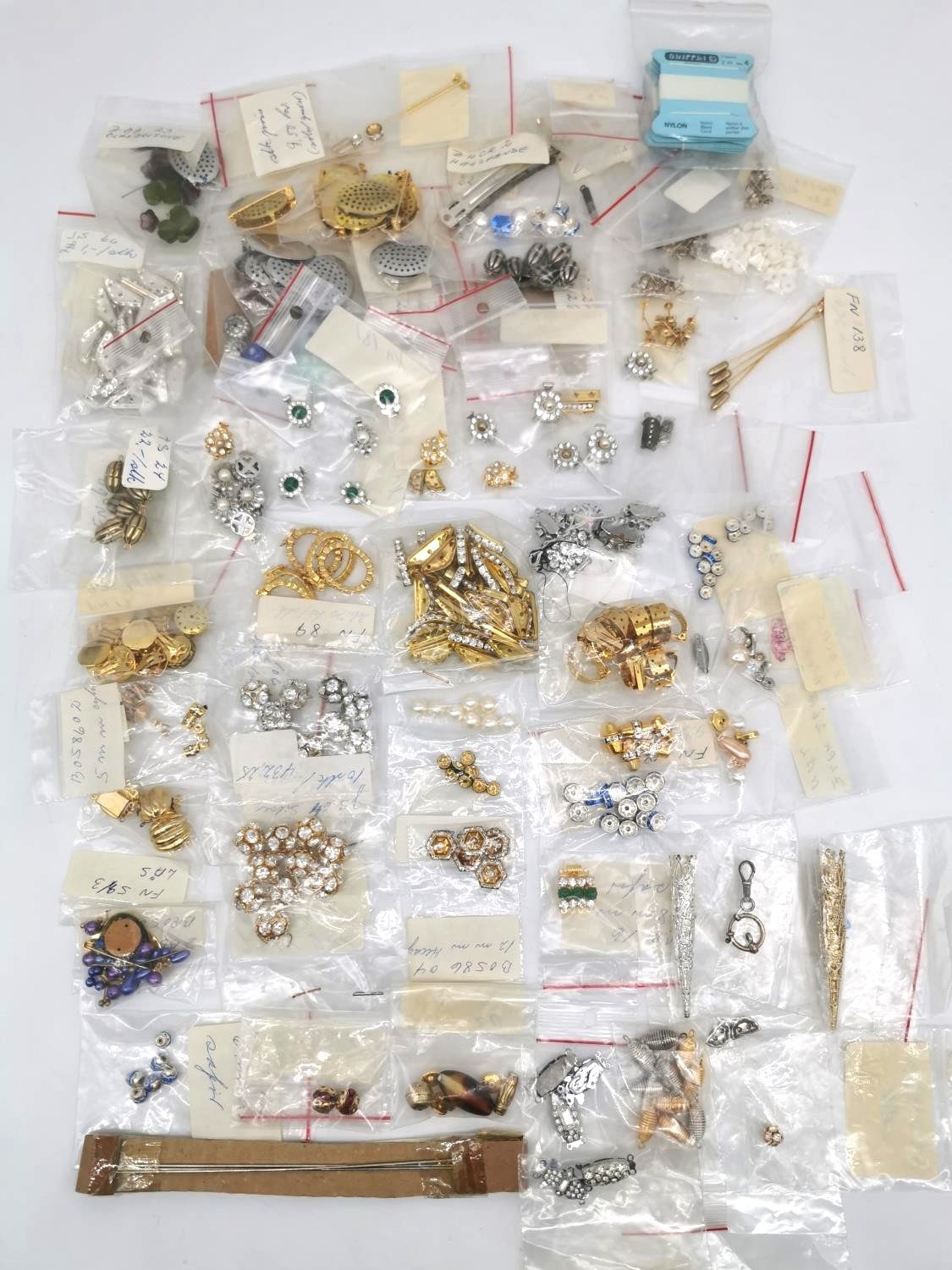 A collection of folk costume fittings, including clasps, spacers, beads and other craft items.