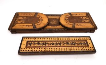 An early 20th century marquetry folding book slide and cribbage board. The book slide with classical