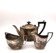A Victorian and Edwardian sterling silver near matching three piece tea set. The gadrooned tea pot