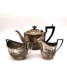 A Victorian and Edwardian sterling silver near matching three piece tea set. The gadrooned tea pot