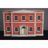 A vintage Tiger Toys Queen Anne dolls house. Scale 1inch=12inch. Has four large rooms, lower