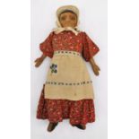 An early 20th century carved wood and cloth child's folk doll with drawn on features. L.32cm (arms