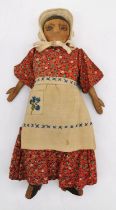 An early 20th century carved wood and cloth child's folk doll with drawn on features. L.32cm (arms