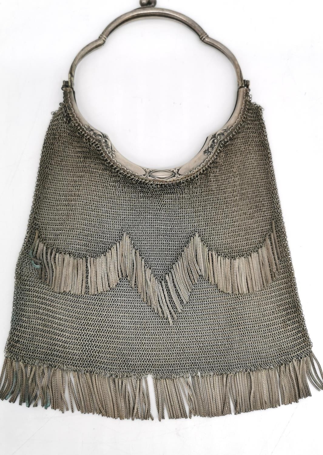 An Alpaca chain mail ladies evening bag with metal fringing and tassel detailing to the sides.