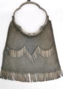 An Alpaca chain mail ladies evening bag with metal fringing and tassel detailing to the sides.