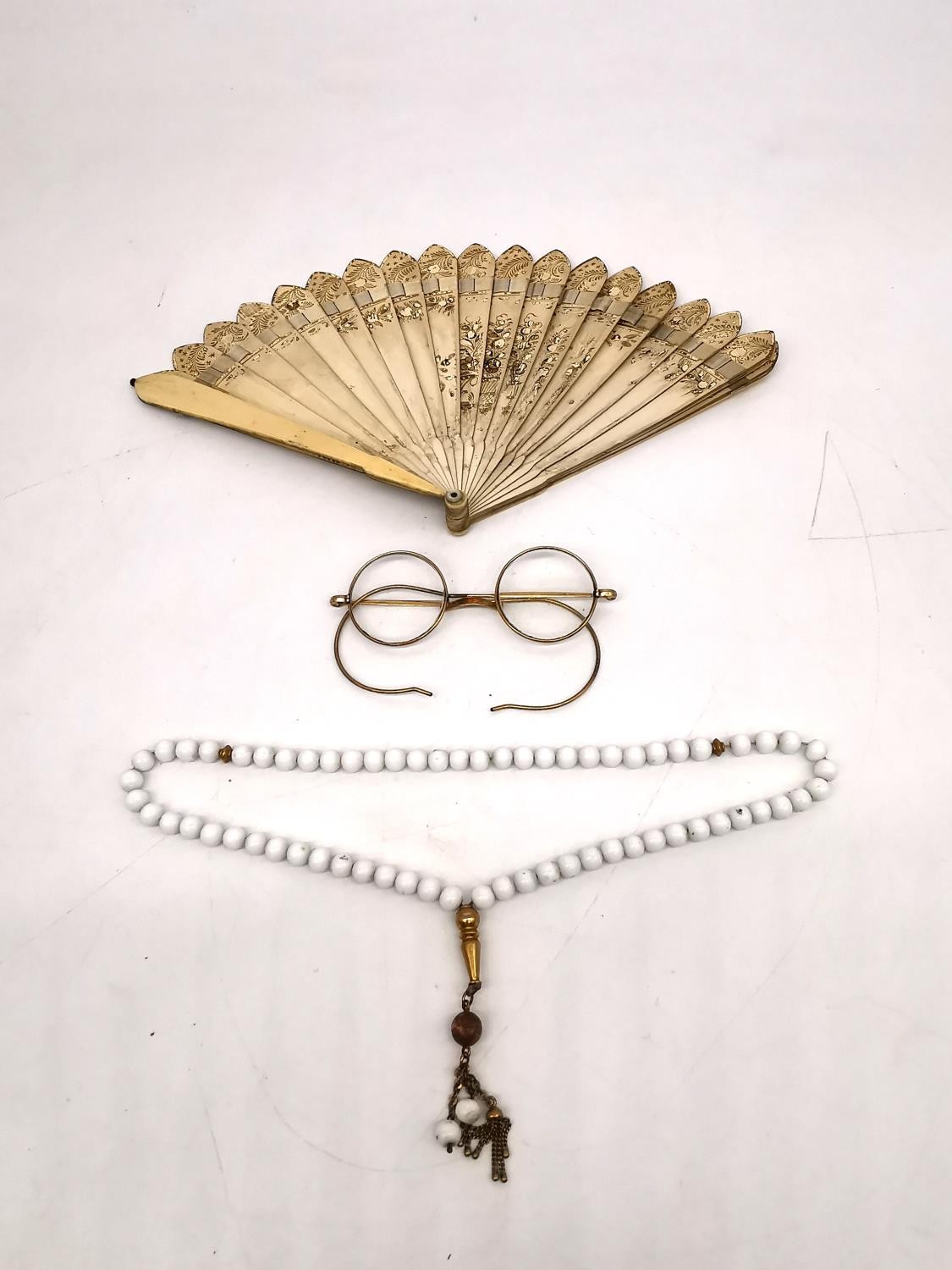 A pair of early 20th century leather cased 10ct gold plated spectacles along with a white glass