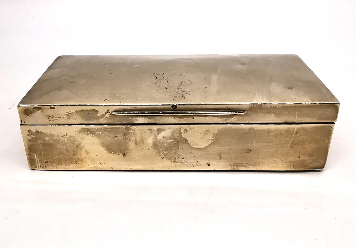 A silver cedar lined cigarette box by Goldsmiths and Silversmiths, Regent Street. Hallmarked: