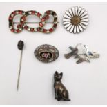 A collection of antique brooches, including a foil backed paste set red and white stone scrolling