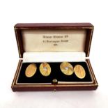 A red leather cased pair of 1920s 18ct yellow gold chain link cufflinks, one panel set with a