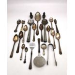 A collection of silver and white metal cutlery and dinnerware, including a large silver serving