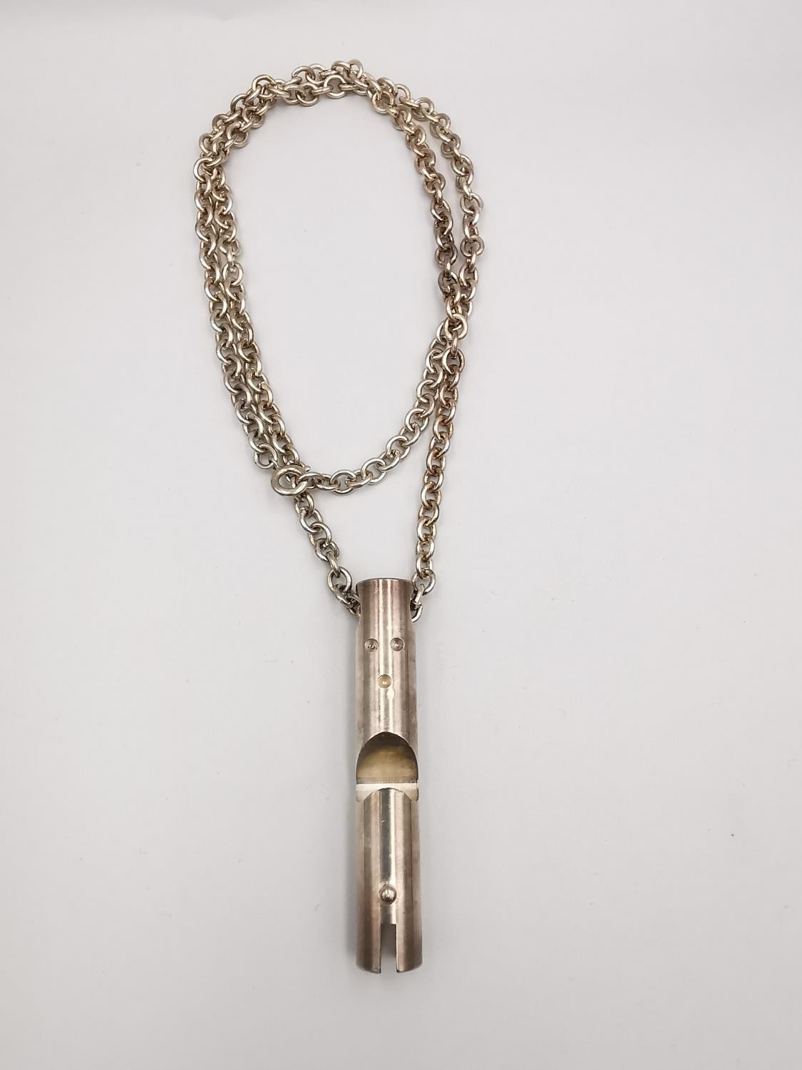 A white metal (tested as silver) brutalist style cylindrical pendant and oval link chain.