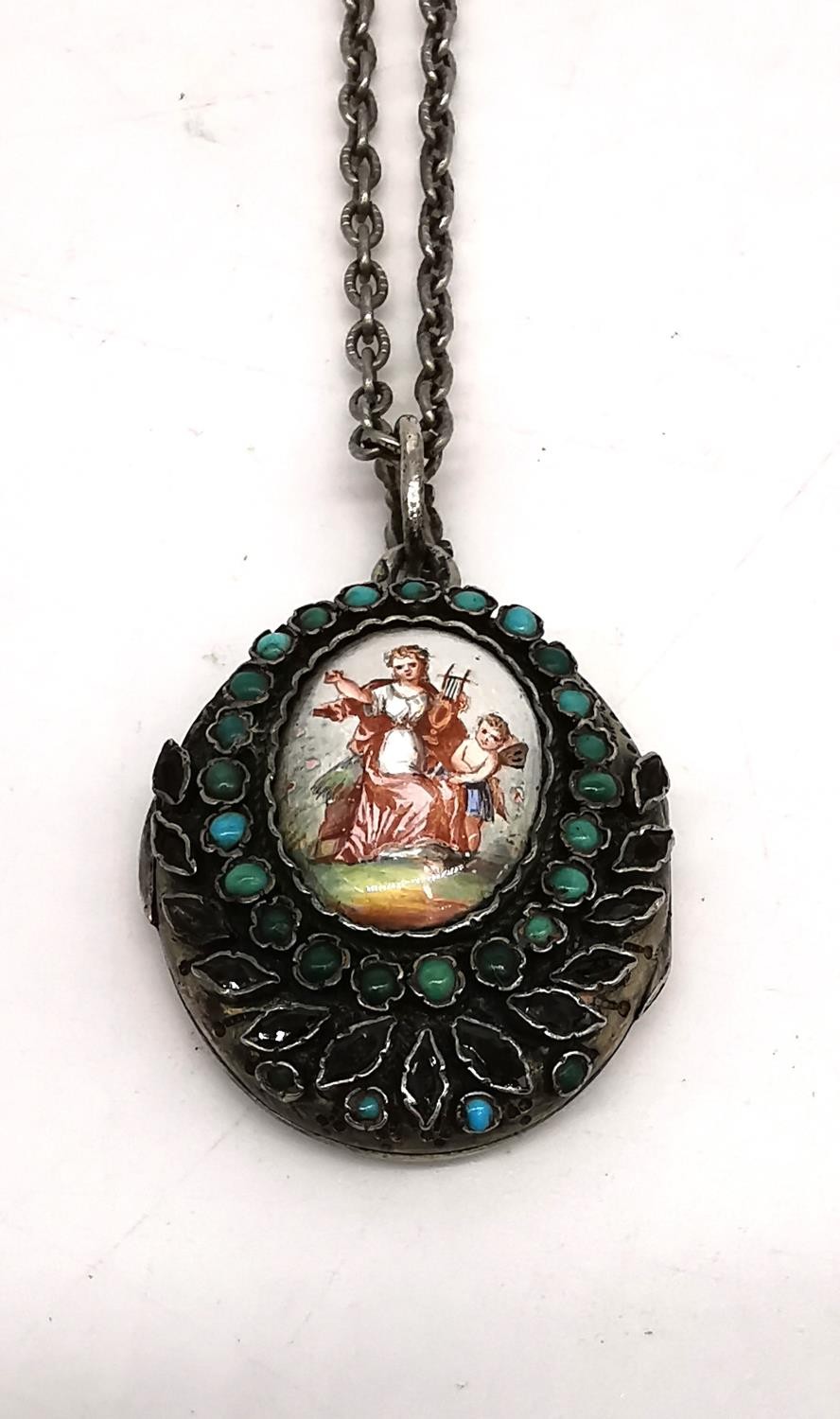 A 19th century white metal locket and metal chain. The front of the locket with an enamel plaque