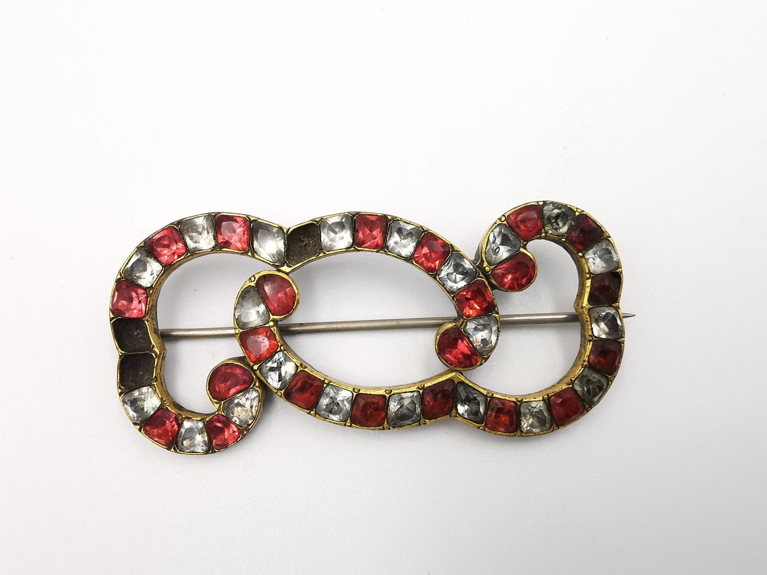 A collection of antique brooches, including a foil backed paste set red and white stone scrolling - Image 4 of 11