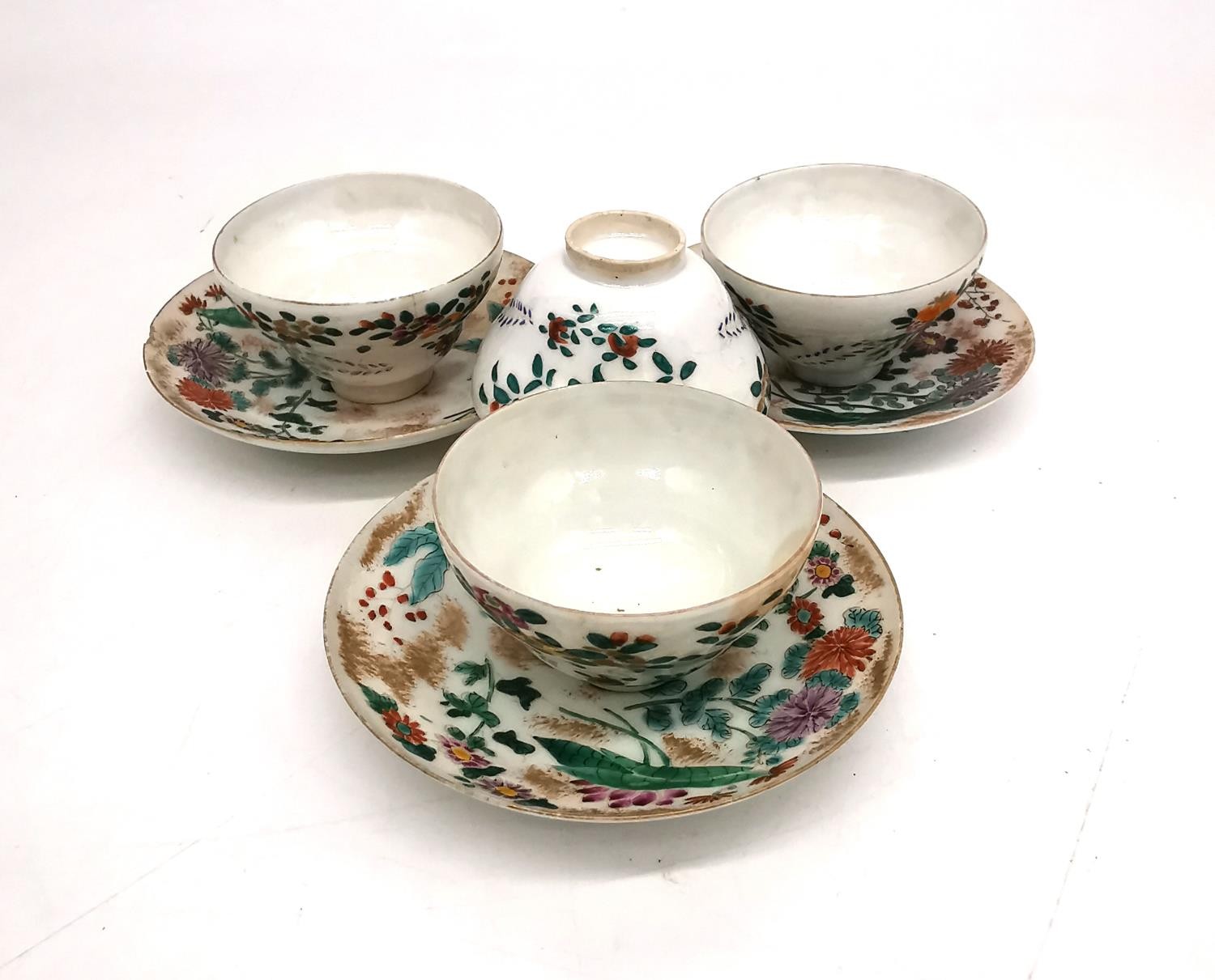 A collection of four Famille rose style egg shell porcelain hand painted tea bowls and three