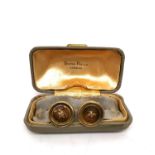 A boxed pair of 14 carat gold cufflinks in the form of buttons with gold wire for the stitch